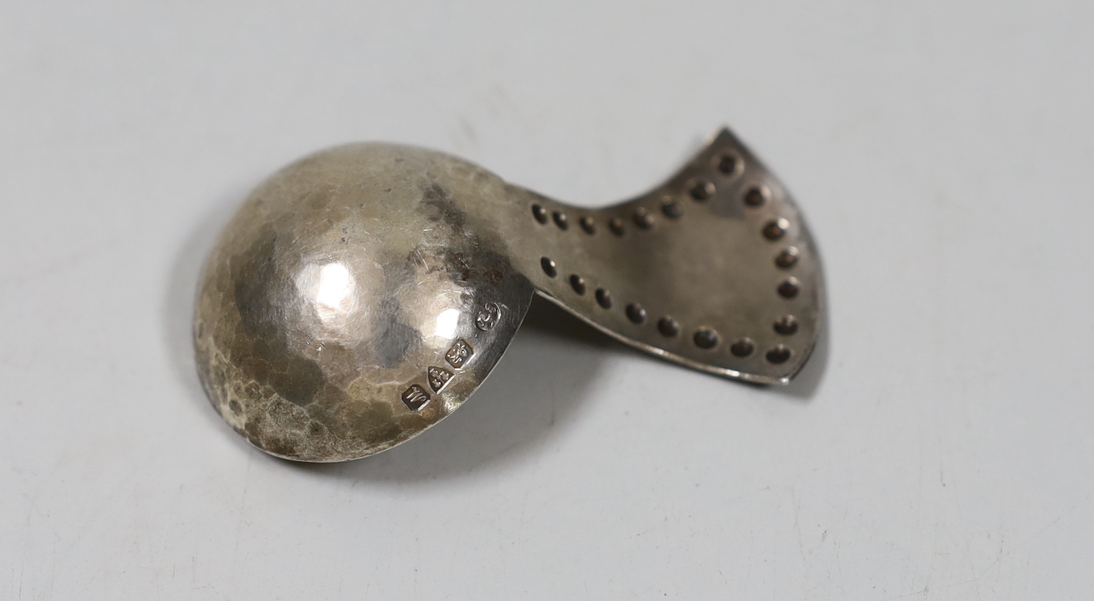 A George V Arts & Crafts silver caddy spoon, by the Keswick Scholl of Industrial Art, with beaded handle, Chester, 1912, 60mm.